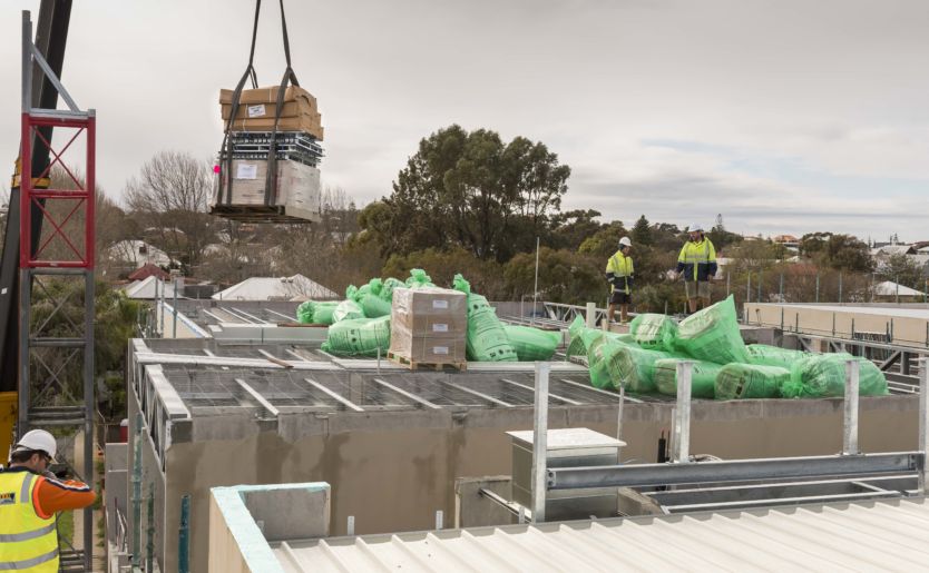Action shot of construction workers loading materials for M/28 Apartments by Match in South Fremantle, which is a snippet from the construction timelapse video in September 2018